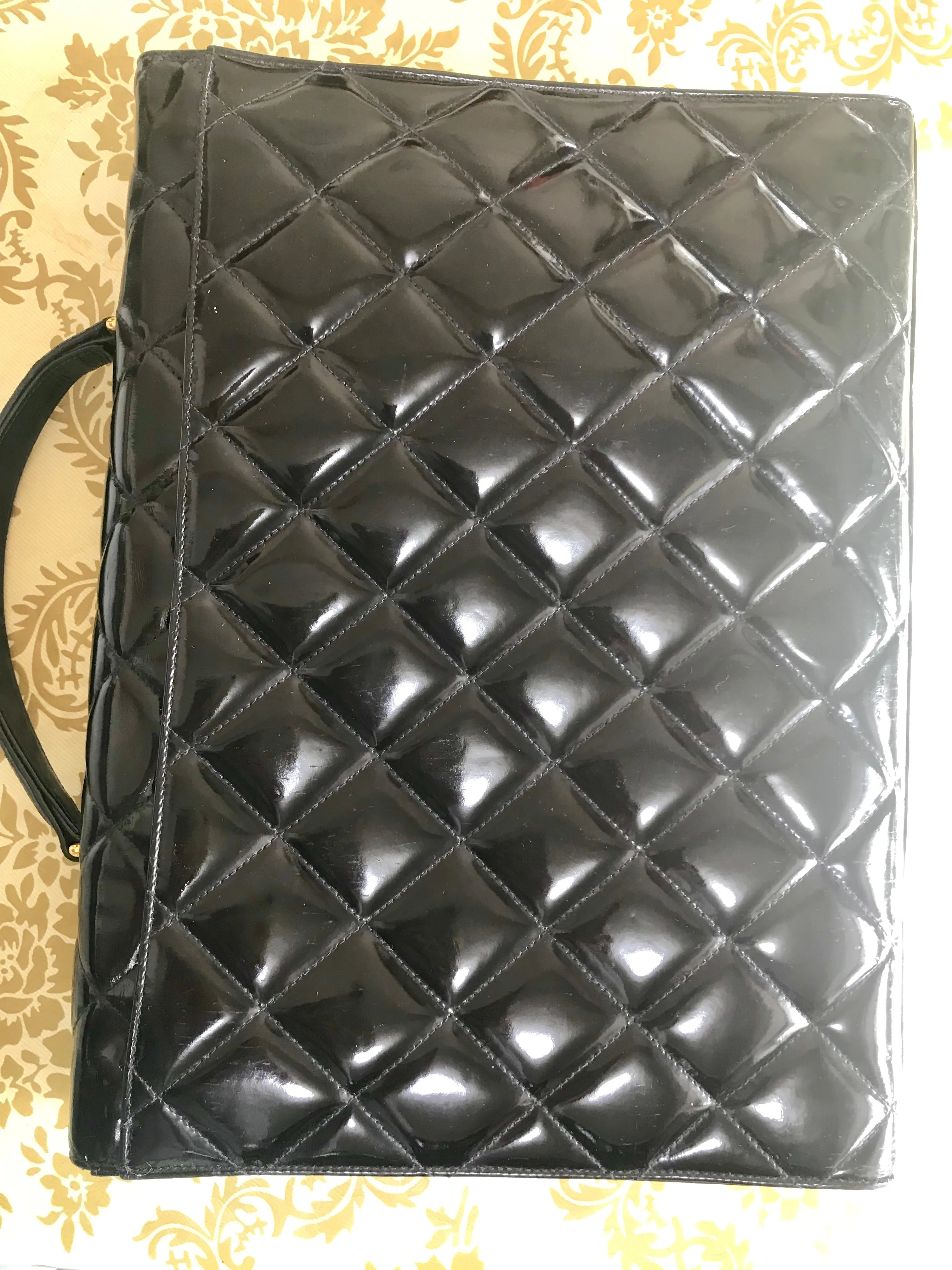 1990s. Vintage CHANEL black patent enamel briefcase business bag with golden large CC motif. Classic and traditional masterpiece you must have.