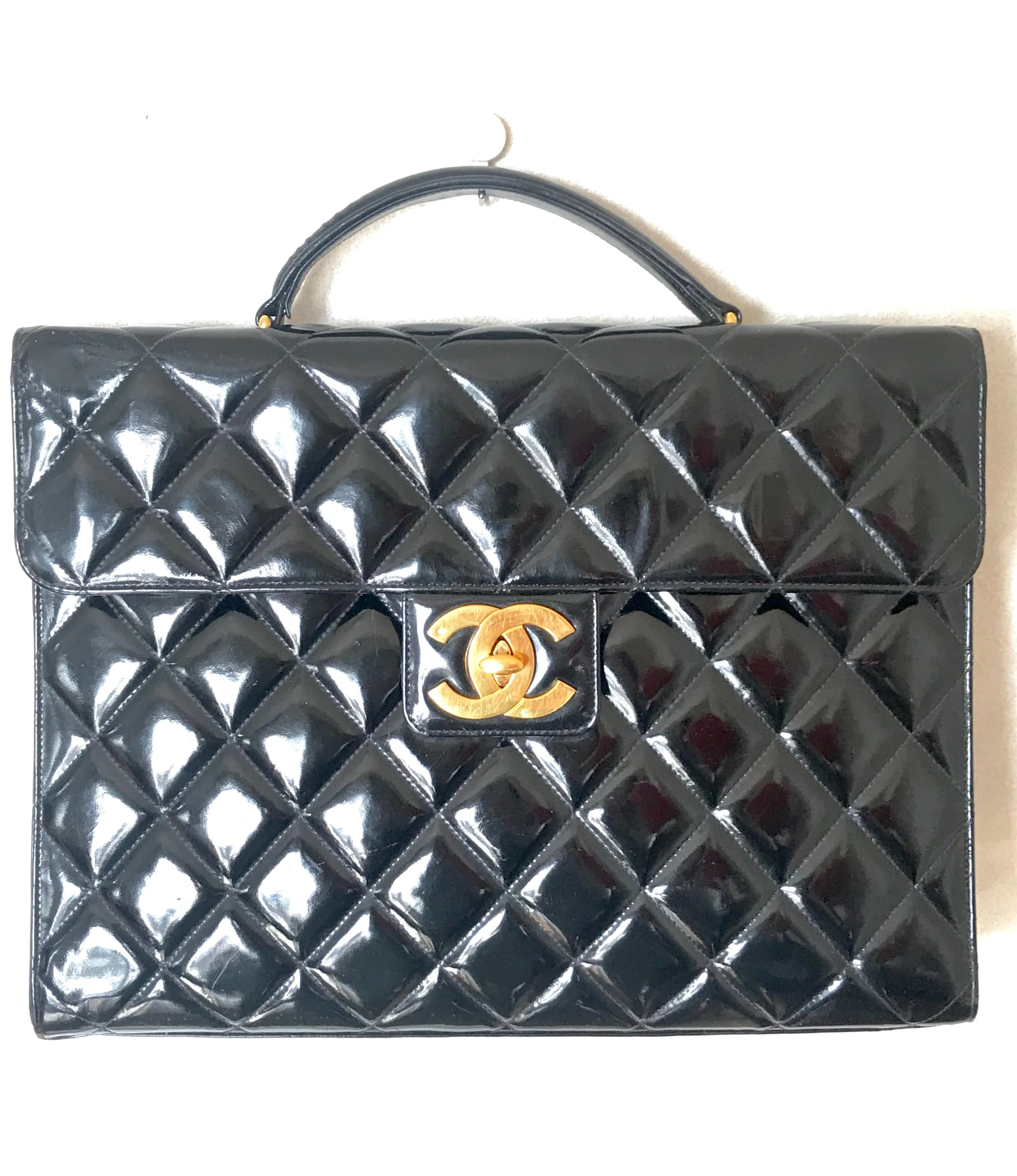 1990s. Vintage CHANEL black patent enamel briefcase business bag with golden large CC motif. Classic and traditional masterpiece you must have.