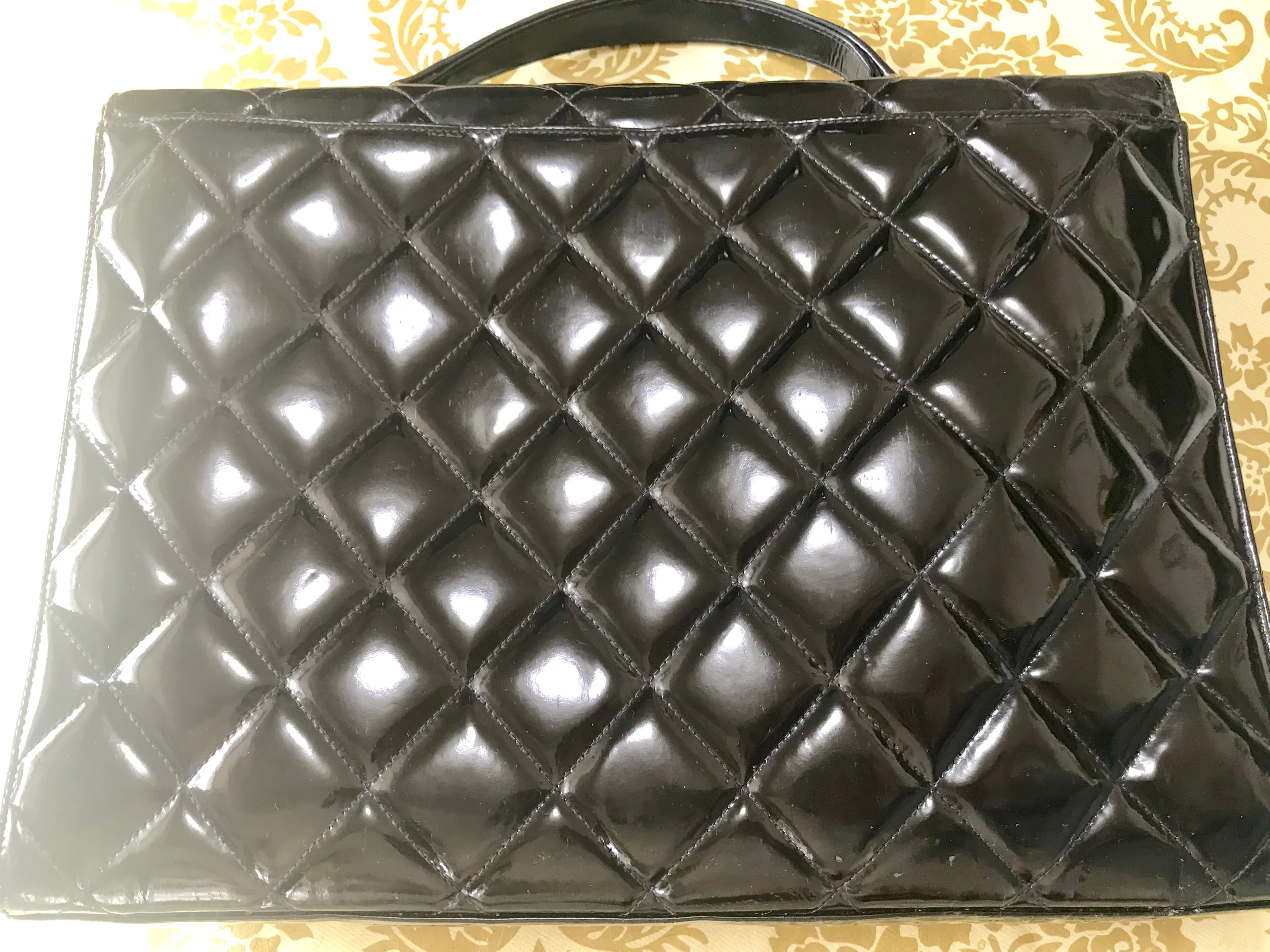 1990s. Vintage CHANEL black patent enamel briefcase business bag with golden large CC motif. Classic and traditional masterpiece you must have.