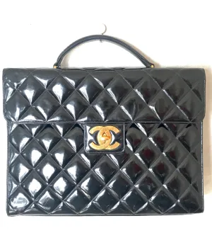 1990s. Vintage CHANEL black patent enamel briefcase business bag with golden large CC motif. Classic and traditional masterpiece you must have.